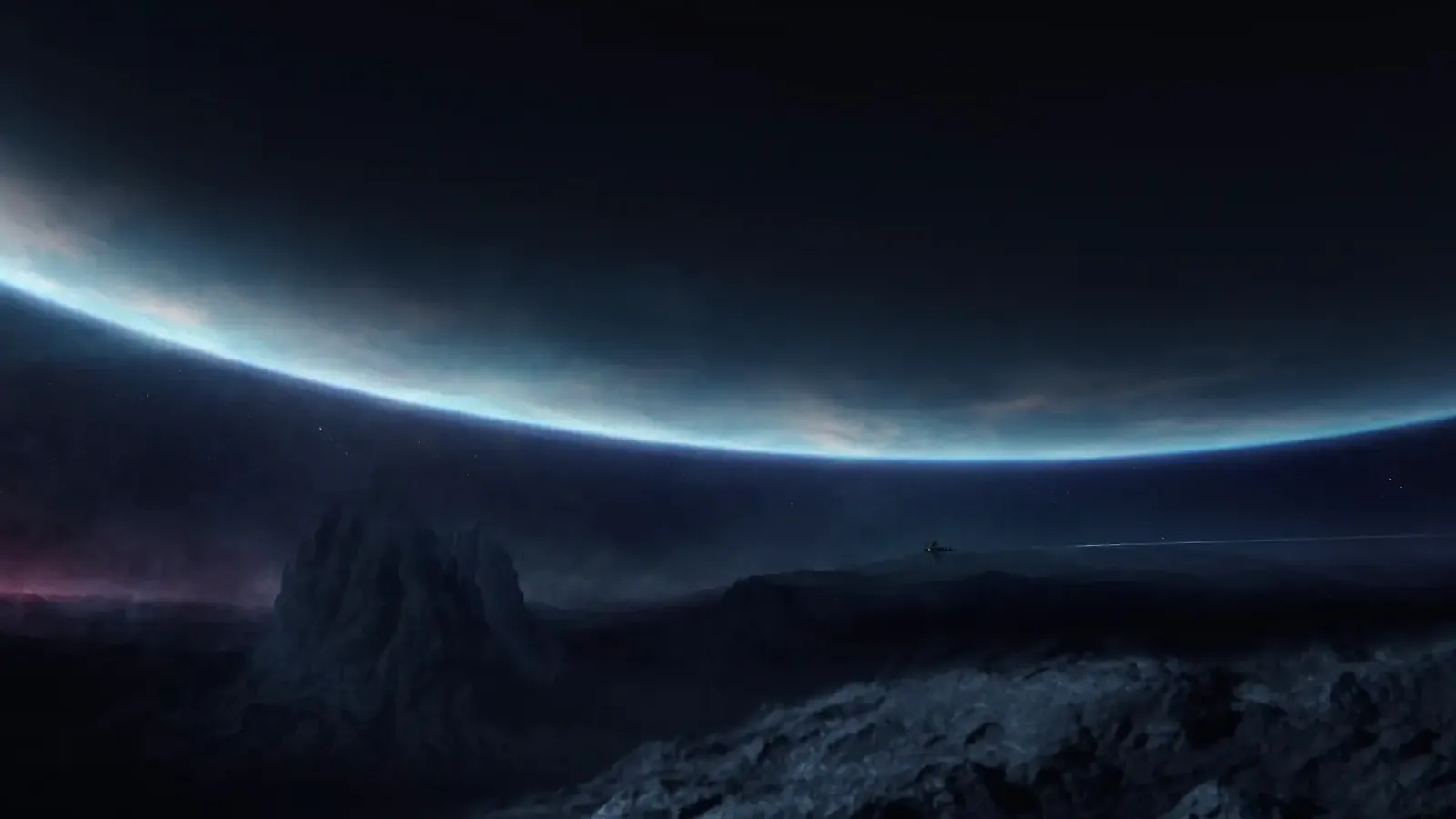 The glowing edge of a planet rising over a dark, rocky landscape