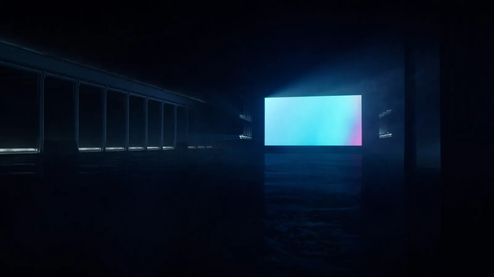 A bright screen glowing at the far end of a long, dark hall
